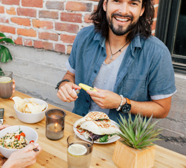 Man holding pipe at a picnic table